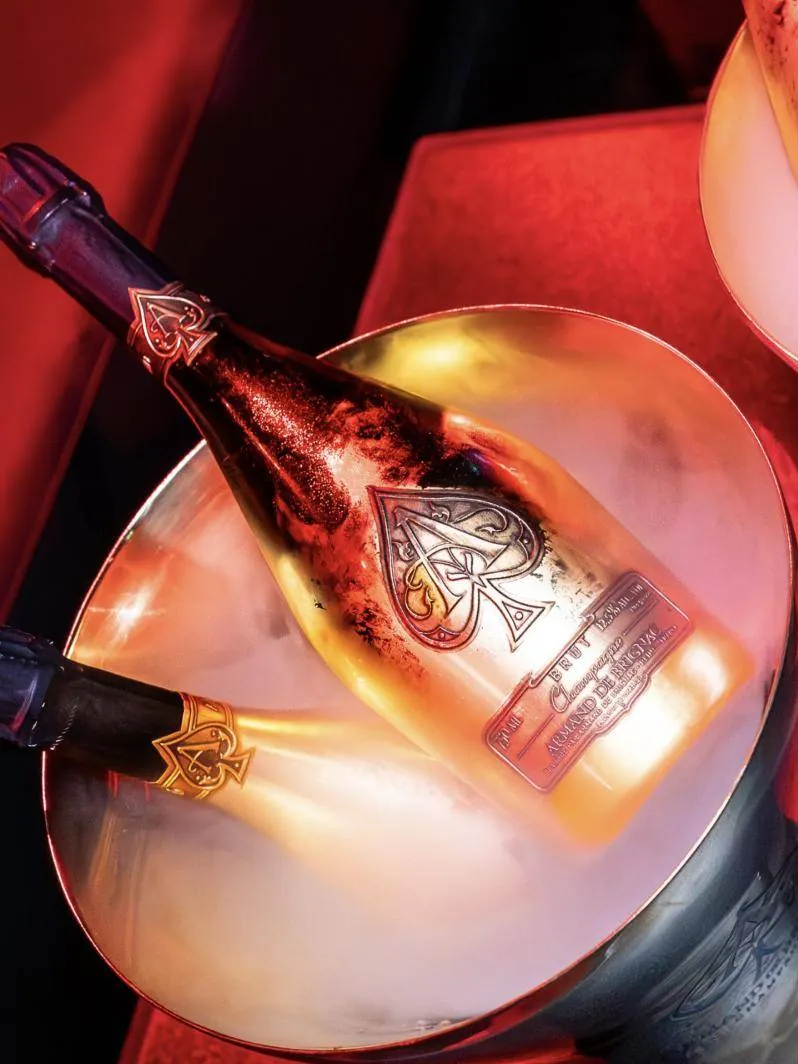 Armand de Brignac on ice under red light