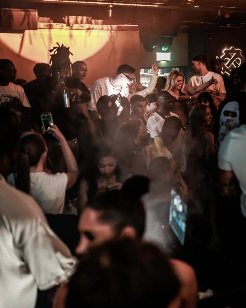 The crowd in warm light and haze