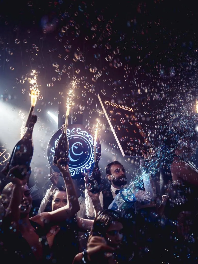 A bottle parade with sparklers and bubbles