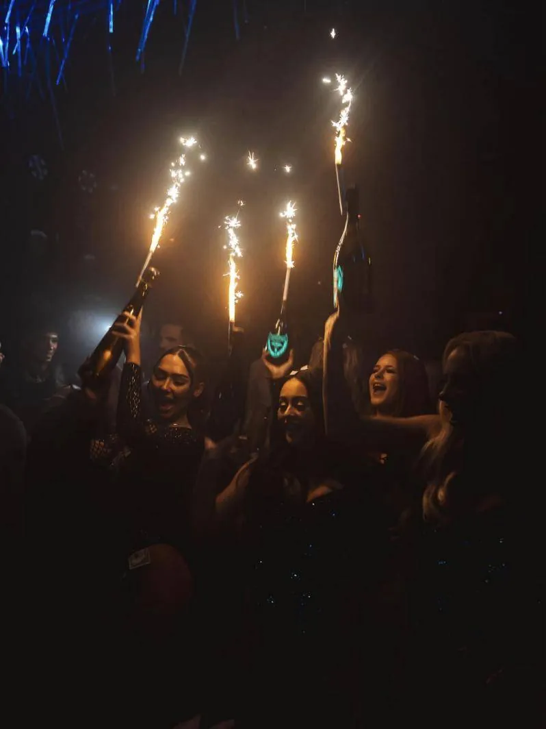 Guests raising sparkler bottles